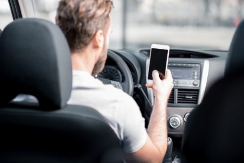 Man Using Phone in Car