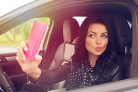 Woman Taking Selfie in Car