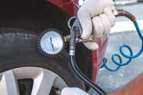 Man Checking Tire Pressure