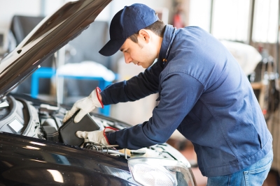 Man Pouring Oil in Engine