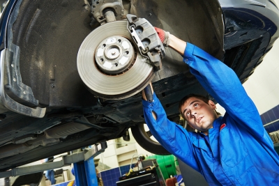 Mechanic Fixing Car Brakes